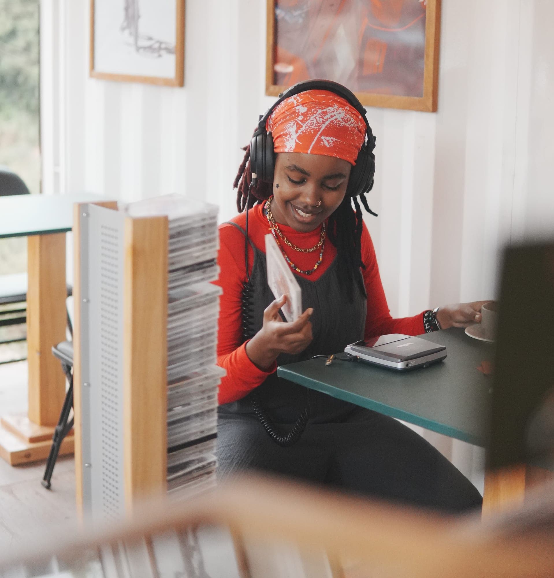 A guest in headphones choosing a track on the Sonique CD player