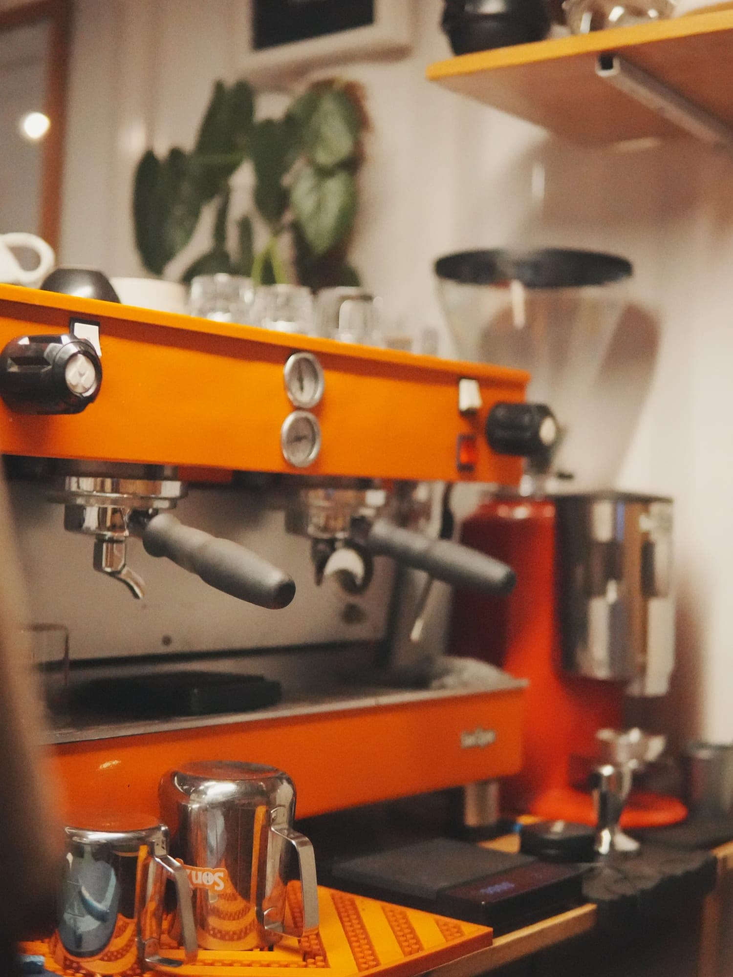 The orange espresso machine and grinder at Sonique