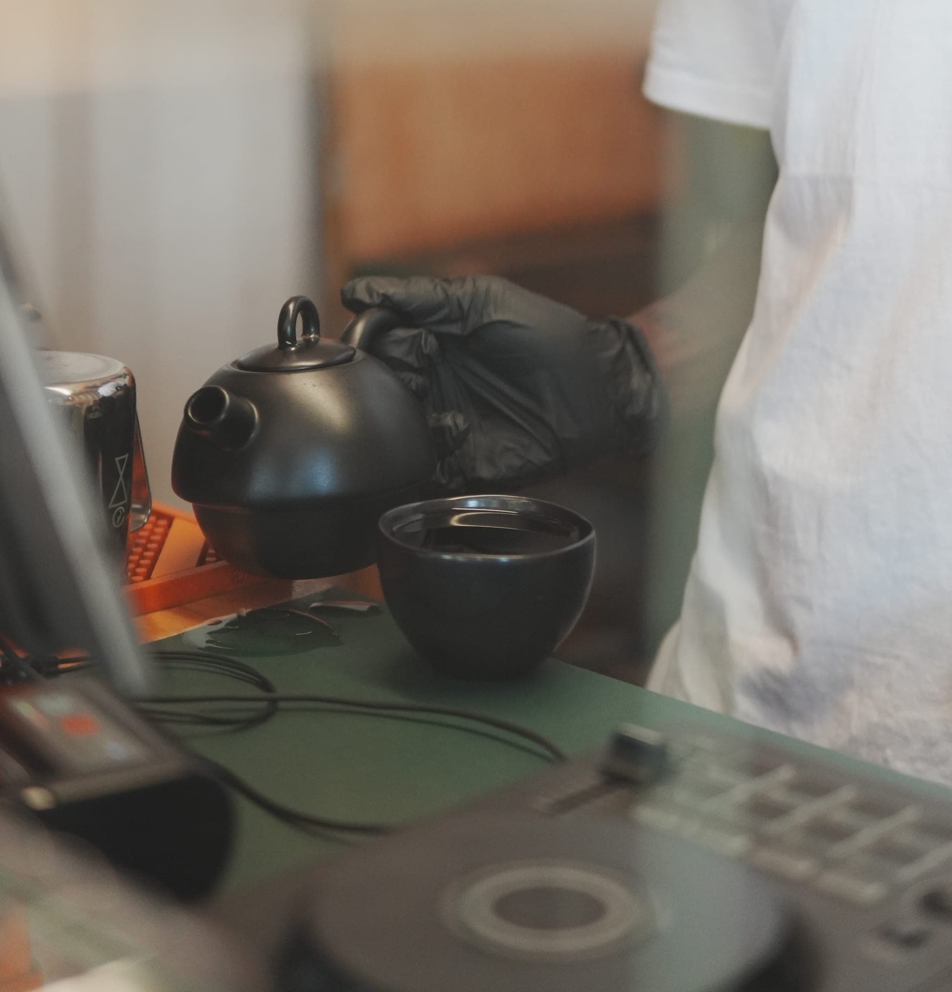 A pot of Sonique house tea beside the decks